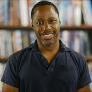 Smiling man with dark hair and a salt-and-pepper goatee